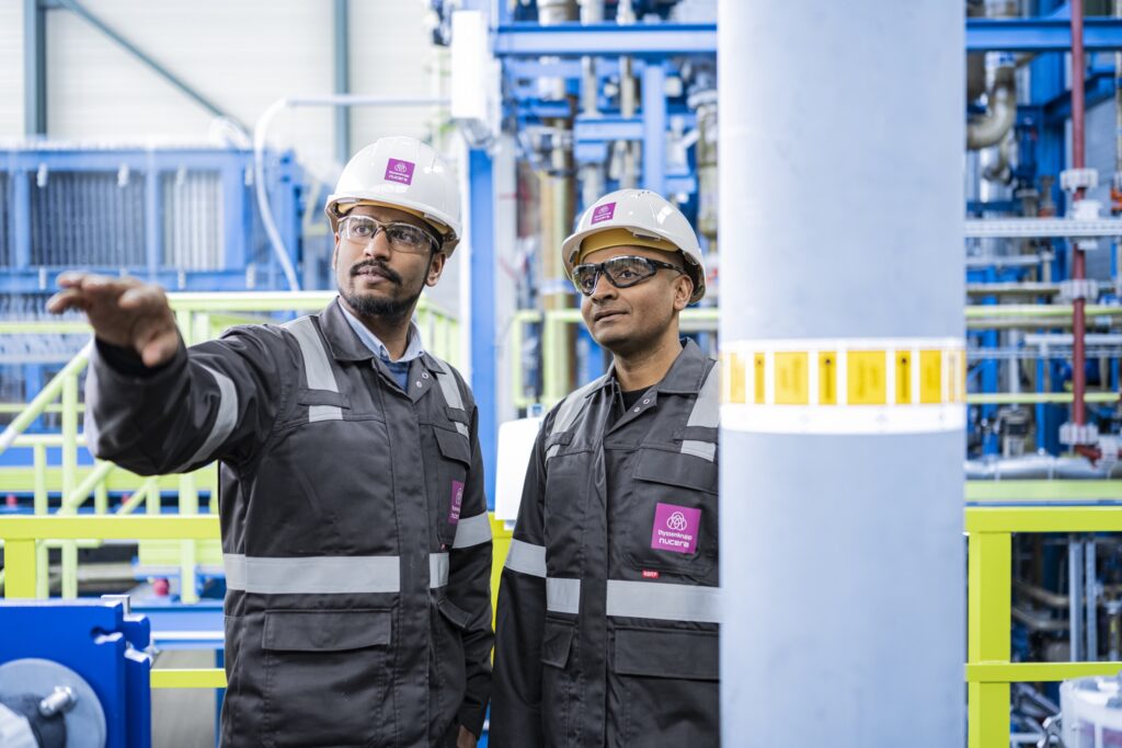 two thyssenkrupp nucera employees talking